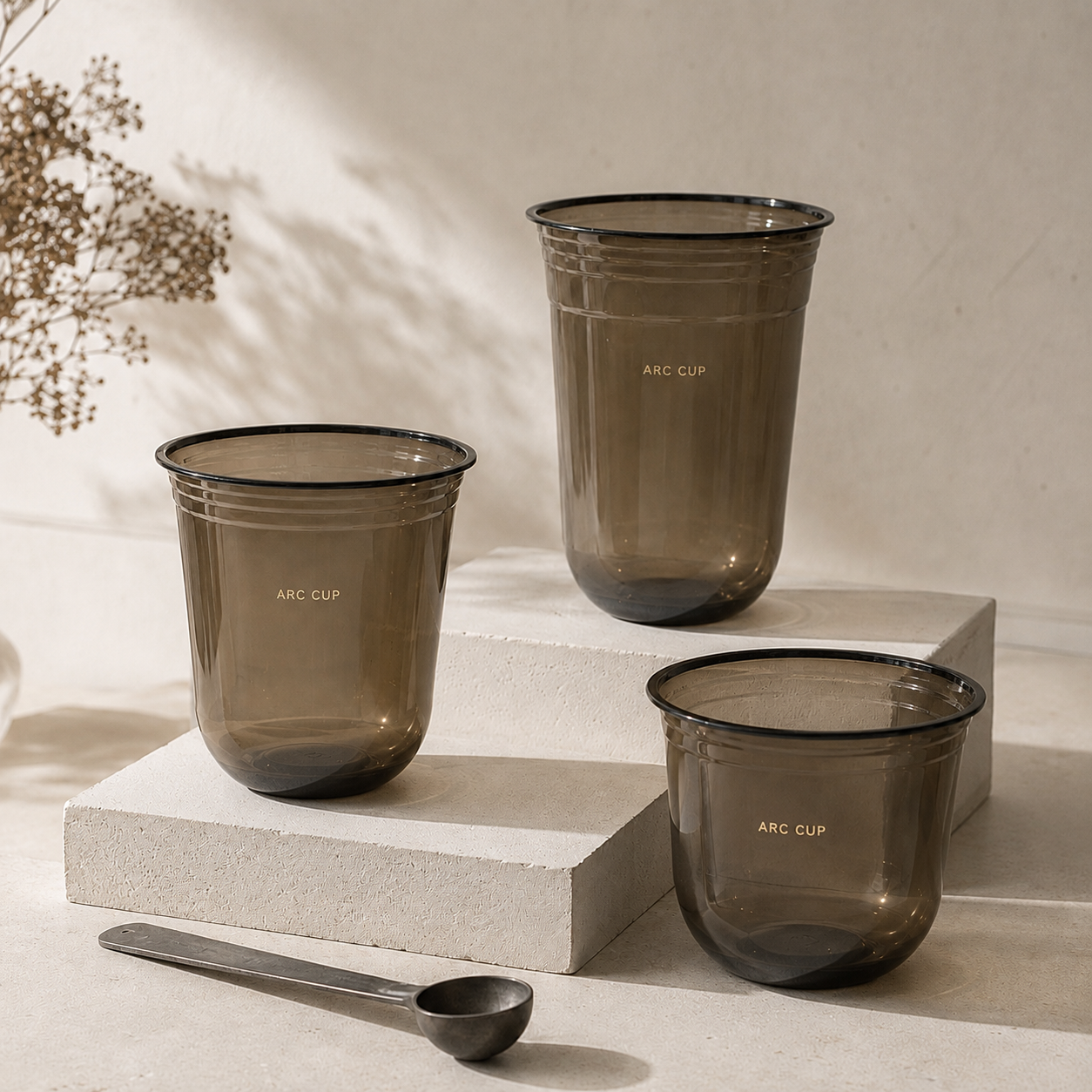 Three black PET cold cups in assorted U-shaped sizes, shown with custom cafe branding.