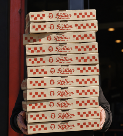 Stack of custom corrugated pizza boxes with logo for takeaway delivery