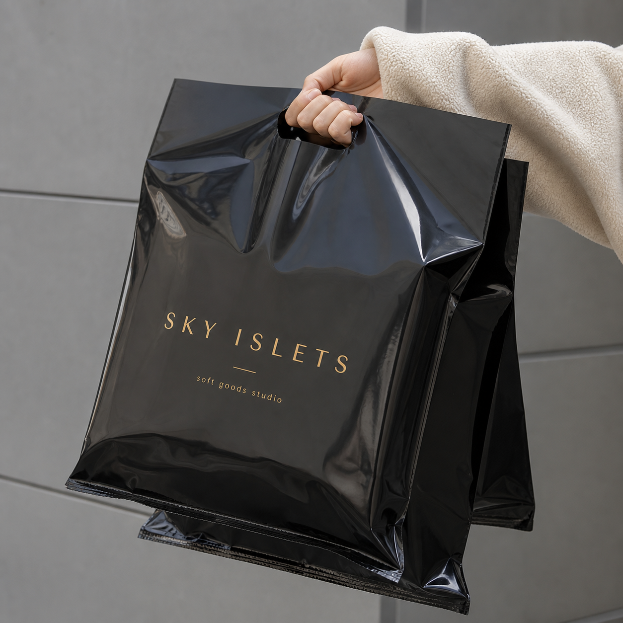 Black custom die cut handle bag with logo shown in retail use