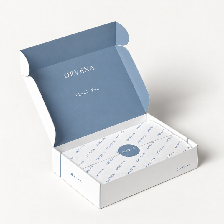 Open blue and white custom mailer box with branded tissue paper inside