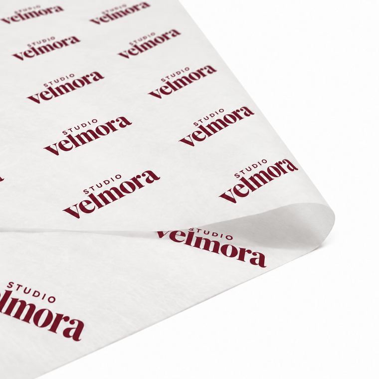 White custom tissue paper printed with a repeating burgundy logo