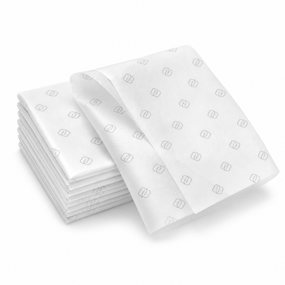 Folded custom printed tissue paper sheets with subtle logo pattern
