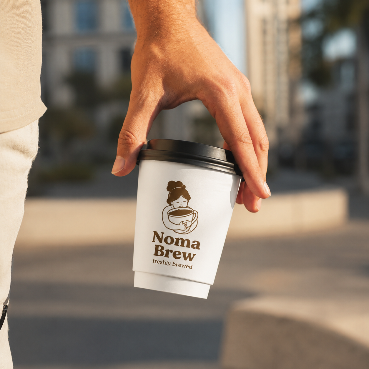 Hand holding custom branded white double wall paper hot cup outdoors — takeaway insulated coffee cup with logo print
