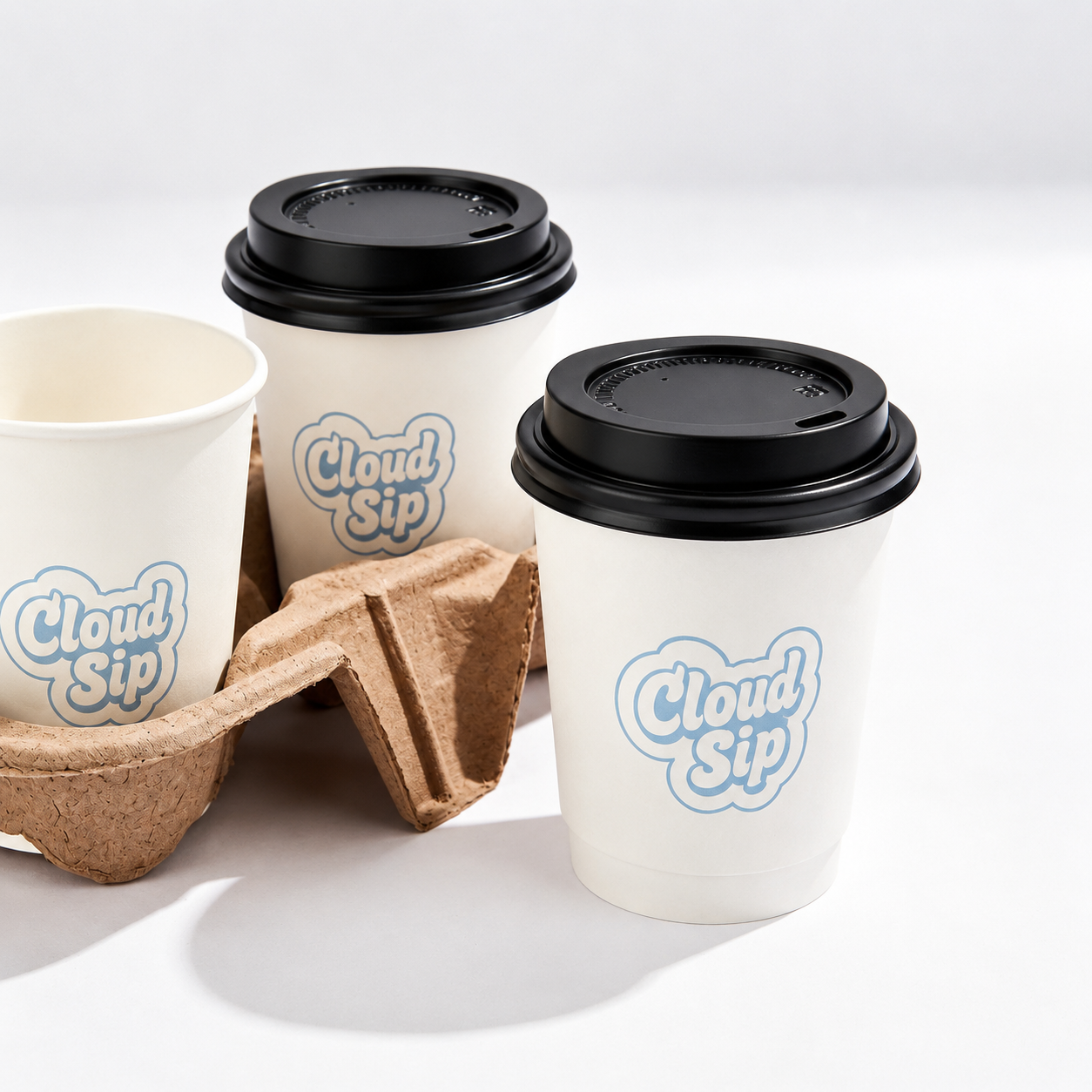 Custom printed white double wall paper hot cups with black lids in cup carrier — branded coffee cups for cafes