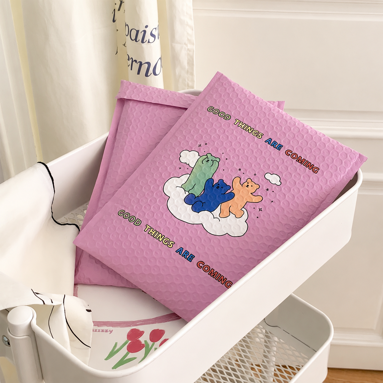 Pink custom bubble mailer in a lifestyle setting for ecommerce packaging and branded order fulfillment.