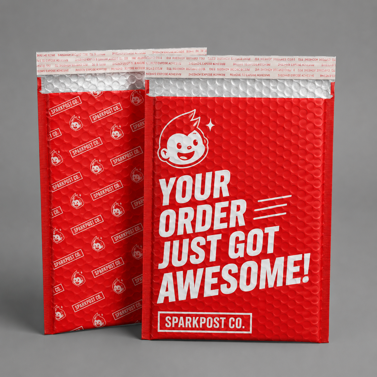 Red custom printed bubble mailers with bold ecommerce branding for padded shipping packaging.