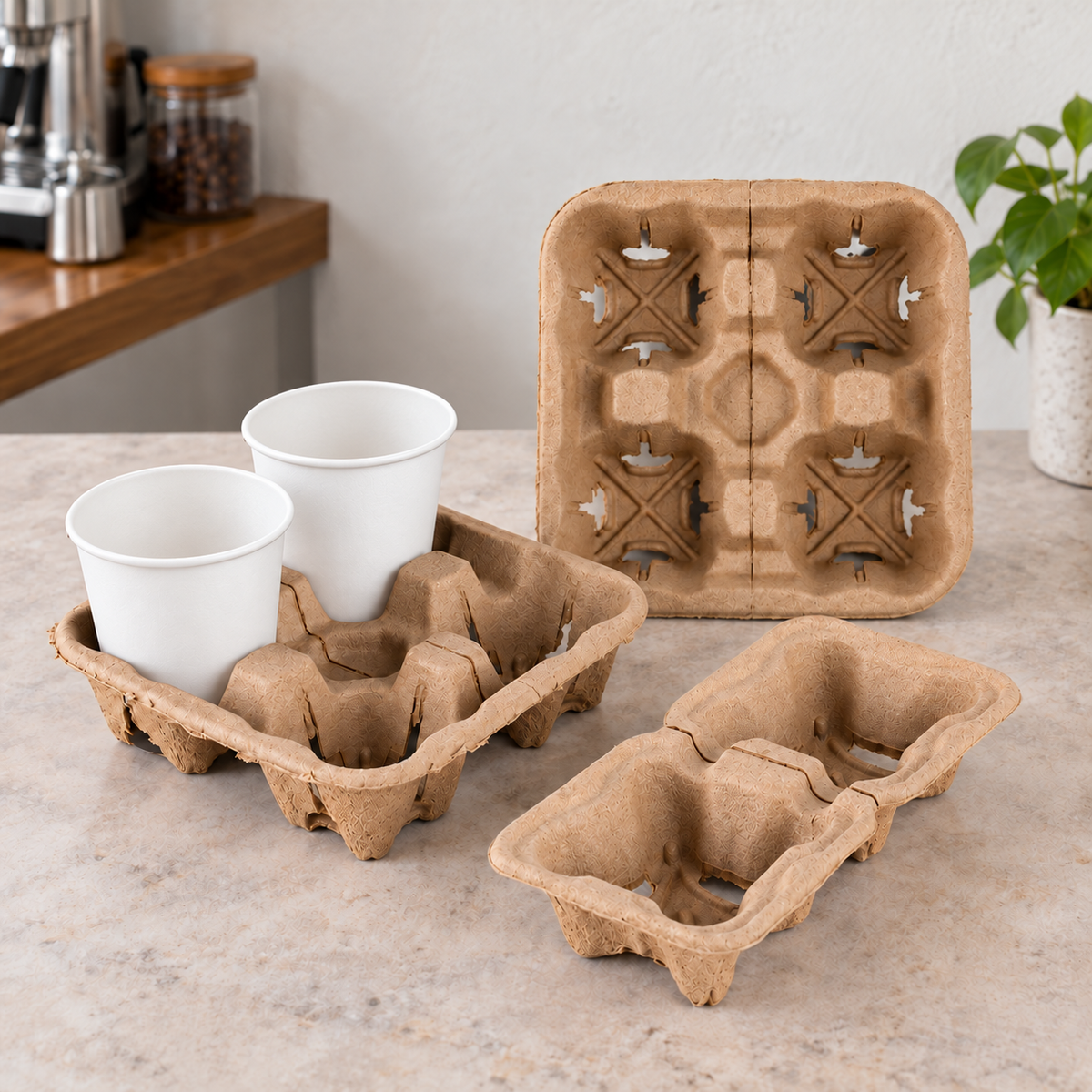 Four-cup molded pulp drink carrier holding two white paper cups beside a separate two-cup carrier