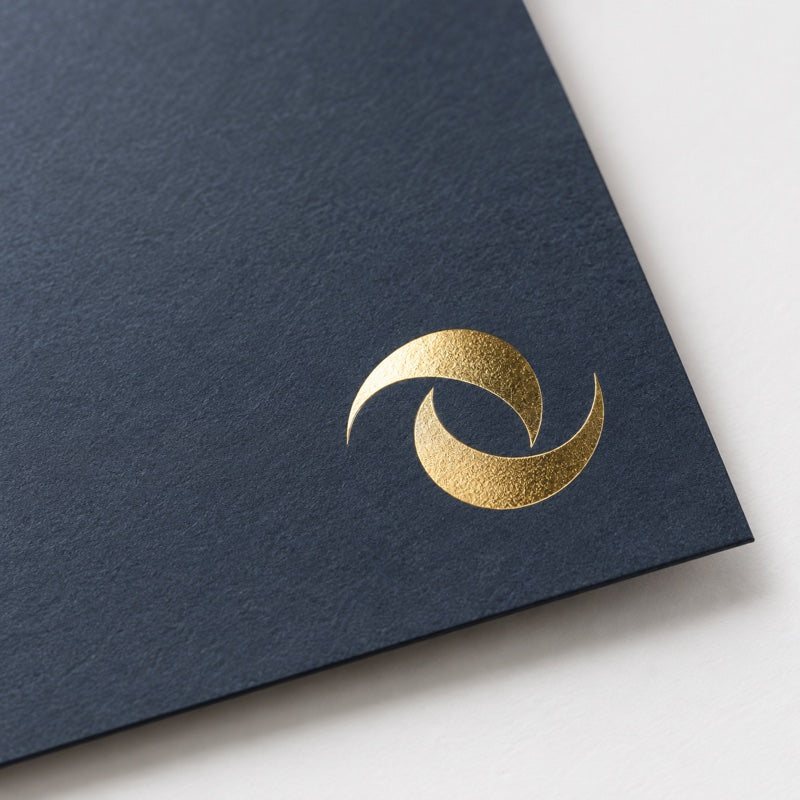 Gold foil stamping finish on dark paperboard