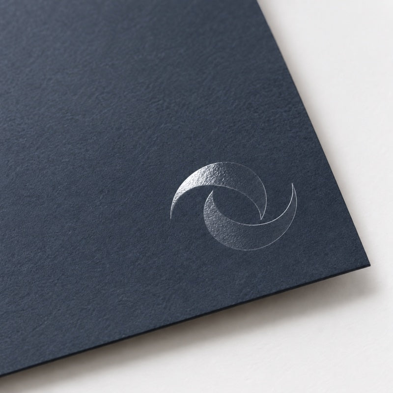 Glossy spot UV detail on dark paperboard